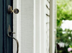 Stock photo of a CENTURY 21 key hanging at a front door, used for a blog about choosing the best REALTOR in Bismarck.